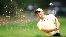 Rory McIlroy playing from a bunker